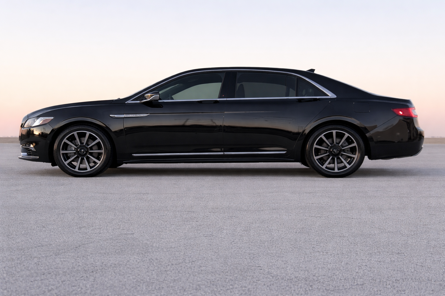 Black luxury sedan side profile